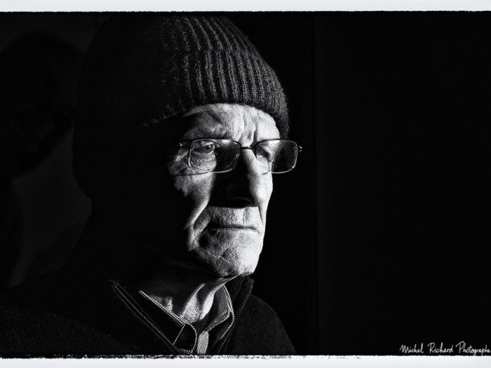 portrait d'homme au bonnet au visage buriné en clair-obscur noir et blanc - portrait au flash par le photographe de portrait à Paris Michel Richard